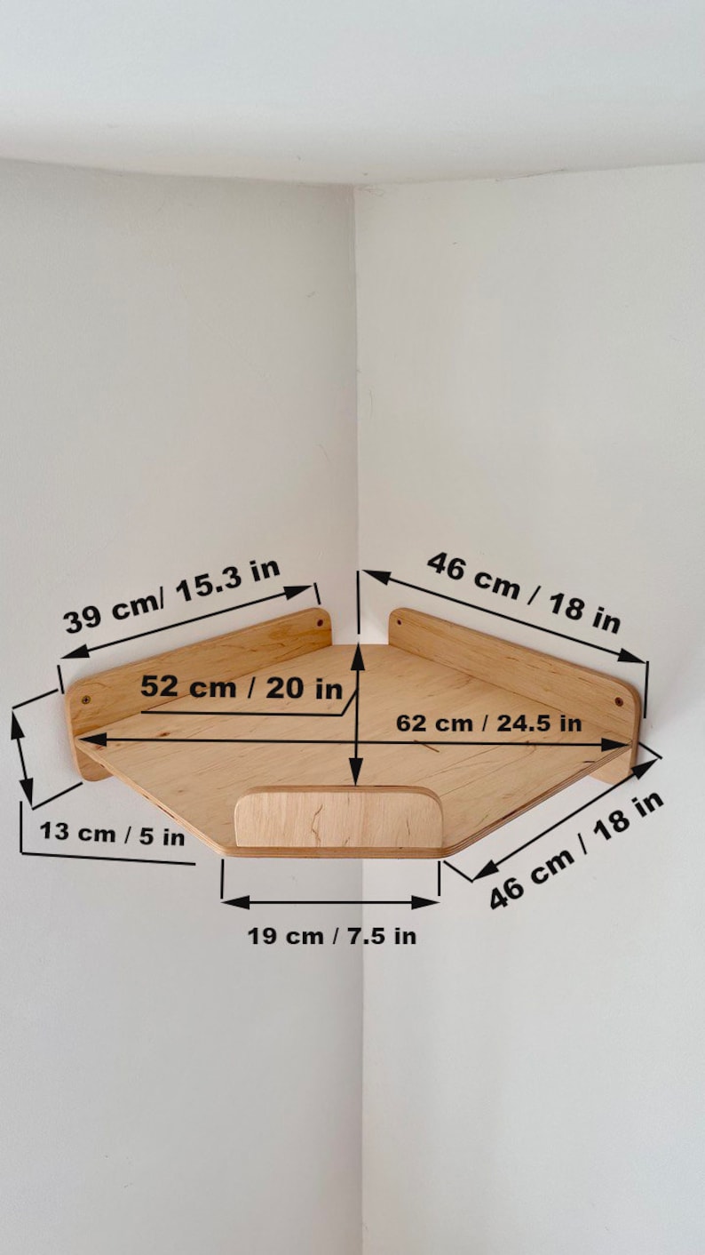 May include: A wooden corner shelf with measurements in inches and centimeters. The shelf is made of light wood and has a simple design. It is 20 inches wide, 18 inches deep, and 24.5 inches long.