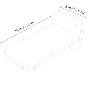 May include: A white wooden shelf with rounded edges, measuring 10 inches by 5 inches. The shelf has a bracket on the back for mounting to a wall.