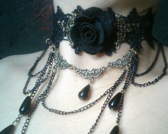 Rose choker with black lace, dangling chains, and black beads.