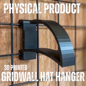 May include: A black 3D printed hat hanger designed to attach to a wire grid wall. The hanger features a curved, semi-circular arm extending from a rectangular mounting bracket that clips onto the grid wires. The text PHYSICAL PRODUCT 3D PRINTED GRIDWALL HAT HANGER is visible.