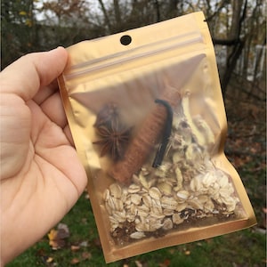 May include: A gold resealable pouch filled with a blend of oats, cinnamon sticks, star anise, and vanilla beans.