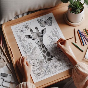 May include: A black and white coloring page featuring a giraffe with a butterfly and flowers. The giraffe is in the center of the page and is surrounded by flowers and leaves.