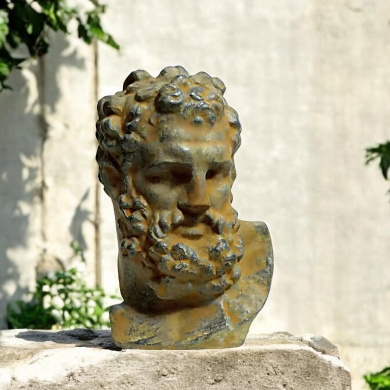 May include: A weathered bronze bust of a man with a beard. The bust is detailed with a textured surface and a realistic depiction of the man's features.