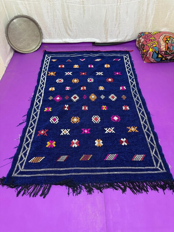 Traditional Berber rug in royal blue with hand-painted symbolic patterns, perfect for decorating any space with an authentic Moroccan feel.