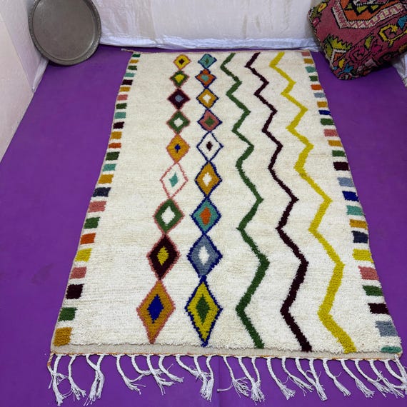 Traditional Moroccan rug decorated with geometric shapes and bright colors.