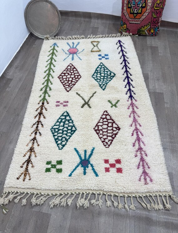 A distinctive Moroccan rug with a design that combines eggs and multiple colors, blending beautifully to add an artistic touch to any space.