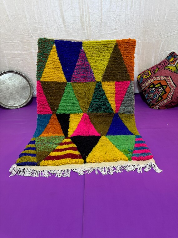 A Moroccan rug with a unique design in blue, orange, and dark green, combining authenticity and modernity in every thread.