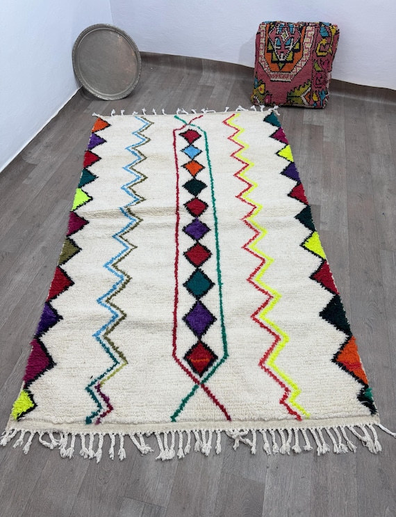 A distinctive Moroccan rug with a design that combines eggs and multiple colors, blending beautifully to add an artistic touch to any space.