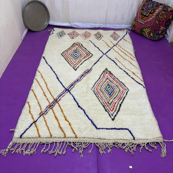 Traditional Moroccan rug decorated with geometric shapes and bright colors.