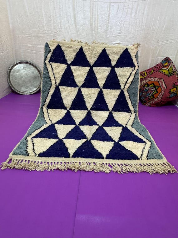 A Moroccan rug with a unique design in blue, orange, and dark green, combining authenticity and modernity in every thread.