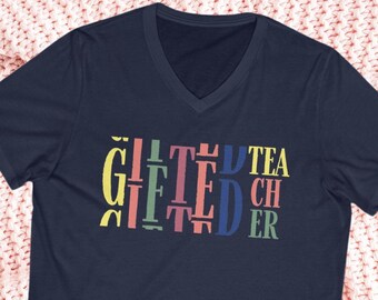 May include: Navy blue v-neck t-shirt with the text "Gifted Teacher" in colourful letters.