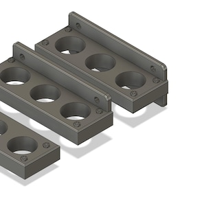 May include: Three gray metal parts with multiple circular holes. The parts are designed to be stacked together.