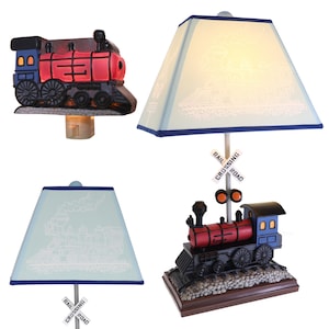 May include: Three different styles of train-themed night lights. The first is a small night light with a red and blue train. The second is a table lamp with a blue and white shade and a train design. The third is a table lamp with a blue and white shade and a train design with a red and blue train base.