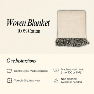 May include: A white woven cotton blanket with black and white fringe. Care instructions are listed below the blanket: Machine wash cold (max 30C or 90F), Gentle Cycle, Mild Detergent, Tumble Dry: Low Heat, Non-chlorine: bleach as needed.