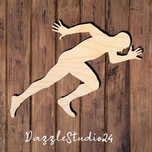 May include: A wooden cutout of a running figure, with arms outstretched and legs in motion, set against a backdrop of vertical wooden planks. The text "DazzleStudio24" is at the bottom.