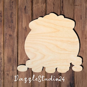 May include: A light-colored, unfinished wooden cutout shaped like a cauldron with a rounded body and a wide rim. The surface displays a natural wood grain pattern. The text DazzleStudio24 is printed in white script at the bottom of the image.