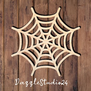 May include: A light-colored, natural wood spider web cutout featuring a symmetrical, multi-layered geometric design with eight radiating spokes. The cutout has a smooth, flat surface and is positioned centrally. The text DazzleStudio24 is visible.