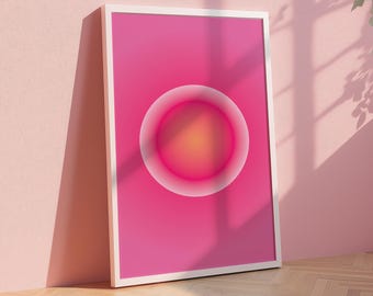 May include: A framed abstract print with a pink background and a large, white-outlined circle with a gradient of pink and orange in the center.