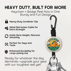 May include: A keychain and badge reel combo with a carabiner clip. The reel features a circular design with a cartoon horse and the word "KETAMINE". The text "HEAVY DUTY, BUILT FOR MORE" is at the top.