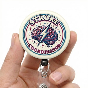 May include: A round, off-white badge with the words "STROKE COORDINATOR" in a retro font. The badge features a brain graphic with a lightning bolt through it, and is attached to a retractable reel.