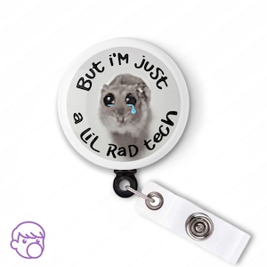May include: White round badge with a cartoon animal with big eyes and a sad expression. The text on the badge reads "But I'm Just a Lil Rad Tech".