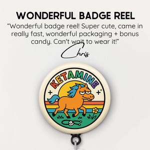 May include: A badge reel with a cartoon horse design. The badge reel has the word "KETAMINE" in a rainbow font. The horse is orange with a blue mane and tail, set against a yellow sun and green grass. The text "WONDERFUL BADGE REEL" is at the top.