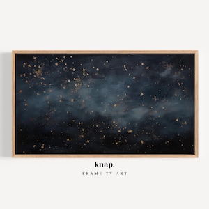 May include: A framed print with a dark blue and navy background, scattered with gold stars and a cloudy effect. The artwork is in a light brown wooden frame. The text "knap. FRAME TV ART" is at the bottom.