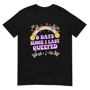 May include: Black t-shirt with a rainbow, butterflies, and the text "0 Days Since I Last Queefed".