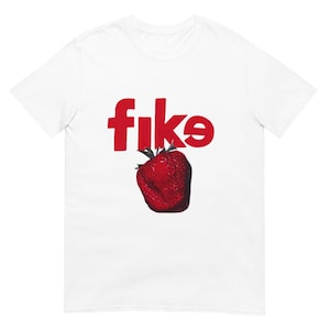 May include: White t-shirt with the word "fike" in red letters and a red strawberry graphic.