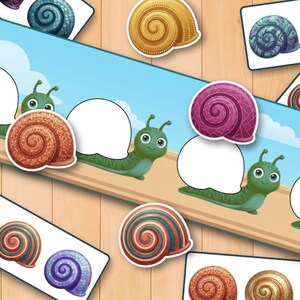 May include: A matching game featuring cartoon green snails with blank white shell spaces and various colorful, patterned snail shell cutouts. The game includes multiple snail shell designs in shades of brown, purple, blue, and orange, displayed on rectangular cards and as individual pieces.