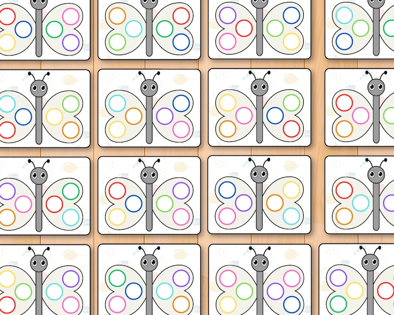 May include: A grid of butterfly-shaped cards with colorful circles on the wings. Each butterfly has a gray body and antennae. The circles are in various colors, including blue, green, yellow, and pink.