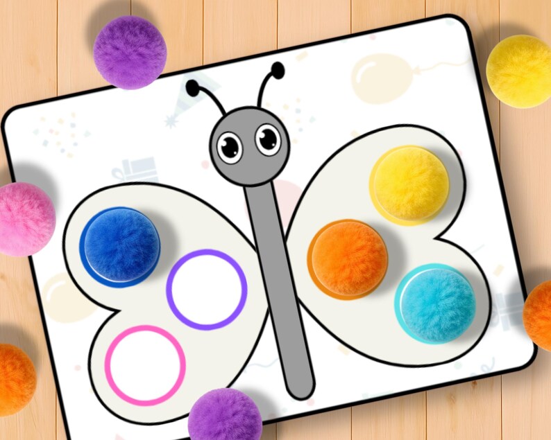 May include: A white butterfly-shaped activity board with colorful, fluffy balls and matching circles. The board features a gray body and antennae, with blue, orange, yellow, and turquoise balls. Additional pink and purple balls are scattered around the board.