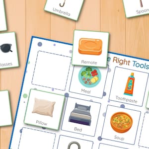May include: A colorful educational game with illustrated cards and the text "The Right Tools." The cards feature images of everyday objects like a remote, sunglasses, key, pillow, bed, and soup. The game is set on a light wood-grain surface.