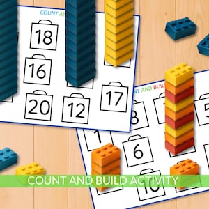 May include: Educational activity with printed cards featuring numbers and shopping bag outlines. Colorful building blocks in blue, yellow, and orange are stacked and scattered around the cards. The text "COUNT AND BUILD ACTIVITY" is visible.