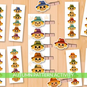 May include: A selection of autumn-themed craft materials, including scarecrow faces with different hat colours. The image shows printed cards with scarecrow faces and wooden pegs. The text "AUTUMN PATTERN ACTIVITY" is visible at the bottom of the image.