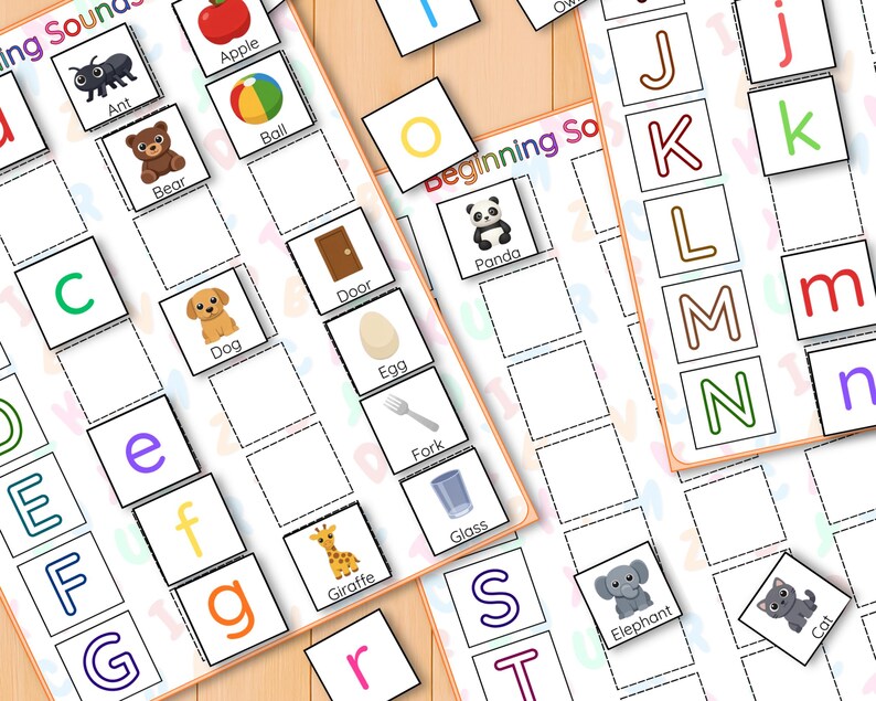 May include: Educational game with alphabet letters and picture cards. Includes images of an ant, apple, bear, ball, dog, door, egg, fork, giraffe, glass, elephant, and cat. Designed to teach beginning sounds.