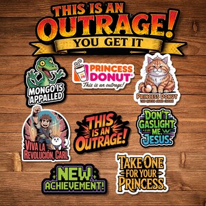 May include: A collection of colorful stickers with various designs and text. The stickers include phrases like "This is an Outrage!", "Mongo is Appalled", and "Princess Donut". The stickers are arranged on a wooden surface.