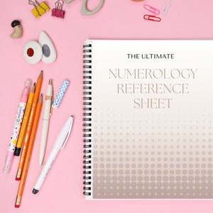 May include: A pink background with a spiral bound notebook that says "The Ultimate Numerology Reference Sheet" on the cover. The notebook has a grey and white polka dot pattern. There are pencils, pens, and erasers on the left side of the image.