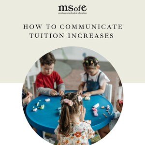 May include: A group of children are sitting around a blue table playing with colorful play dough. The table is in a classroom setting with a light brown wall in the background. The children are wearing casual clothing.