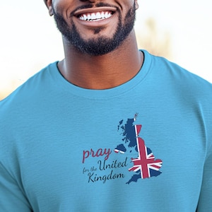 May include: A light blue long-sleeved t-shirt with a graphic of the United Kingdom map and the text "pray for the United Kingdom".