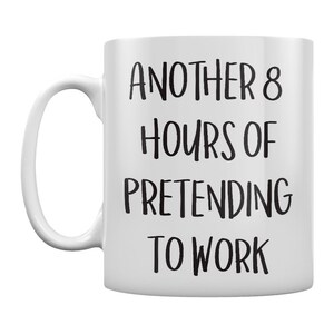 Op de afbeelding: Een witte keramische koffiemok met een zwarte inscriptie die "Another 8 hours of pretending to work." luidt.