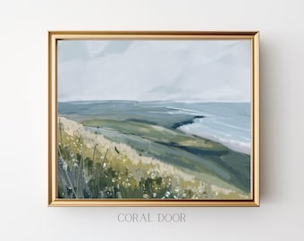 May include: A painting of a landscape with a grassy hill leading to a blue ocean. The sky is a light blue with white clouds. The painting is framed in a gold frame.