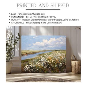 May include: A canvas print of a landscape painting featuring a river, wildflowers, and a blue sky with clouds. The artwork is displayed indoors. The text "PRINTED AND SHIPPED" is at the top of the image.