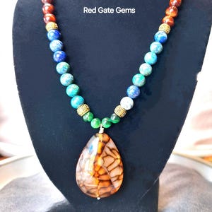 One of a kind semi precious Fire agate gem pendant on boho beaded azurite gem and pearl statement necklace.