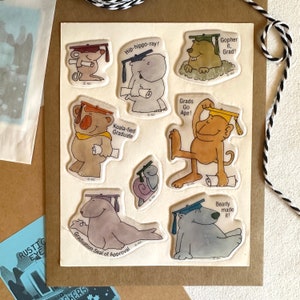 May include: A set of nine graduation themed stickers featuring various animals wearing graduation caps and holding diplomas. The stickers are printed on clear plastic and have a glossy finish. The animals include a hippopotamus, a koala, a monkey, a gopher, a seal, and a polar bear.