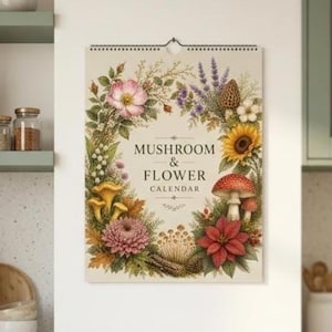 May include: A wall calendar titled MUSHROOM & FLOWER CALENDAR, featuring a central cream-colored panel surrounded by a botanical wreath of colorful flowers, green foliage, and various mushrooms, including a prominent red-capped mushroom.