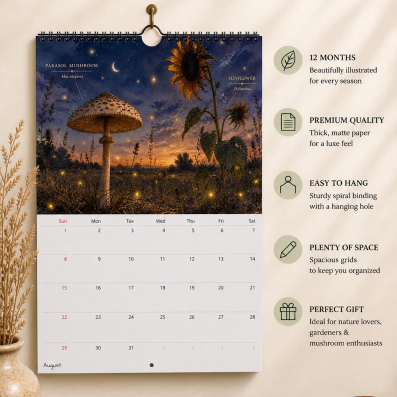 May include: A wall calendar featuring a spiral binding and a hanging hole. The top section displays an illustration of a parasol mushroom and a sunflower in a field at twilight with fireflies. The bottom section shows a grid for the month of August.