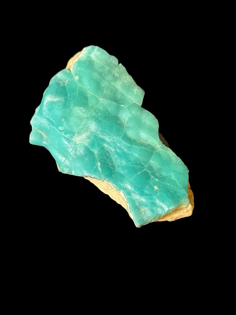 High quality Blue Aragonite on matrix specimen from Crazy Ohio Crystals, weighing 150 grams and measuring 3.5 inches wide, showcasing vibrant aqua-blue crystals on natural earthy base.