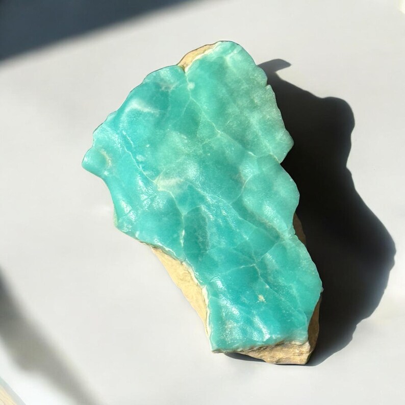 High quality Blue Aragonite on matrix specimen from Crazy Ohio Crystals, weighing 150 grams and measuring 3.5 inches wide, showcasing vibrant aqua-blue crystals on natural earthy base.