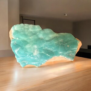 High quality Blue Aragonite on matrix specimen from Crazy Ohio Crystals, weighing 150 grams and measuring 3.5 inches wide, showcasing vibrant aqua-blue crystals on natural earthy base.